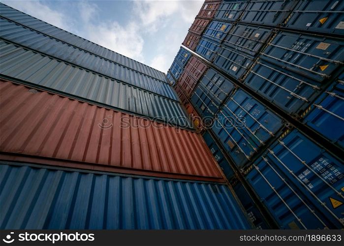 Cargo container for overseas shipping on high stack look up from ground . Logistics supply chain management and international goods export concept .. Cargo container for overseas shipping on high stack look up from ground
