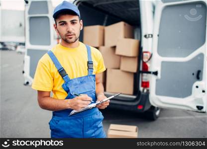 Cargo delivery service, male courier in uniform and truck with cardboard boxes.Empty container. Cargo delivery, courier and truck with boxes