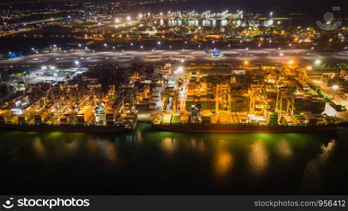 cargo loading station for international export and import by ship with containers open sea aerial view at night over lighting in Thailand