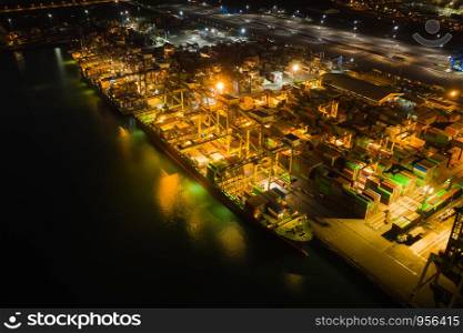 cargo loading station for international export and import by ship with containers open sea aerial view at night over lighting in Thailand