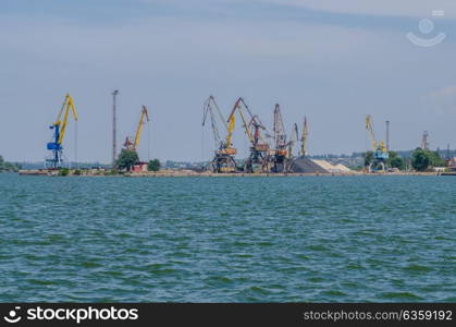 cargo port with cargo cranes on a blue sky background