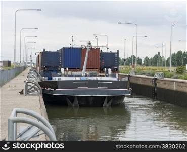 cargo ship in the maas river lock in holland
