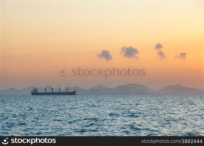 cargo ship in the morning. Morning orange sunlight Clouds covered the sky