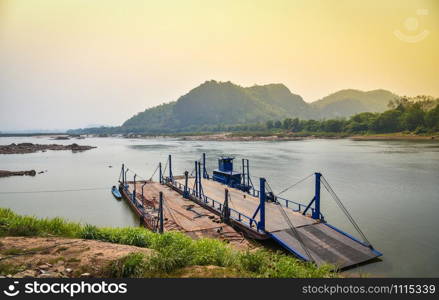 Cargo ship on riverside in the mekong river Asia / Boat ferry Thailand and Laos