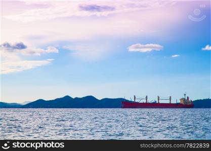 cargo ship Parked in the middle of the sea. Morning clouds and sky.