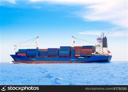 cargo ship with containers in dep blue ocean sea