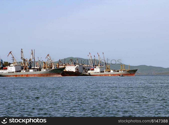 Cargo ships are in port for loading.