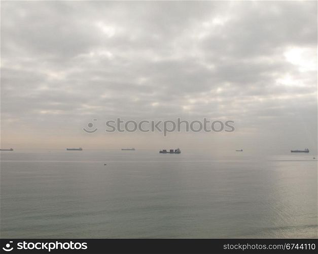 cargo ships. cargo ships waiting in front of a harbor in spain