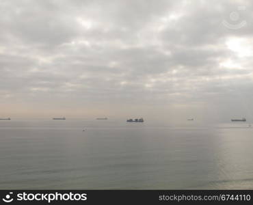 cargo ships. cargo ships waiting in front of a harbor in spain