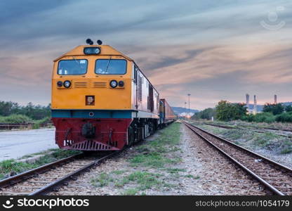 Cargo train and container at twilight of Thailand