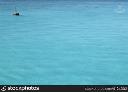 Caribbean turquoise sea with floating buoy far away
