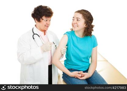 Caring female doctor giving a vaccination to a nervous teen girl. Isolated on white.