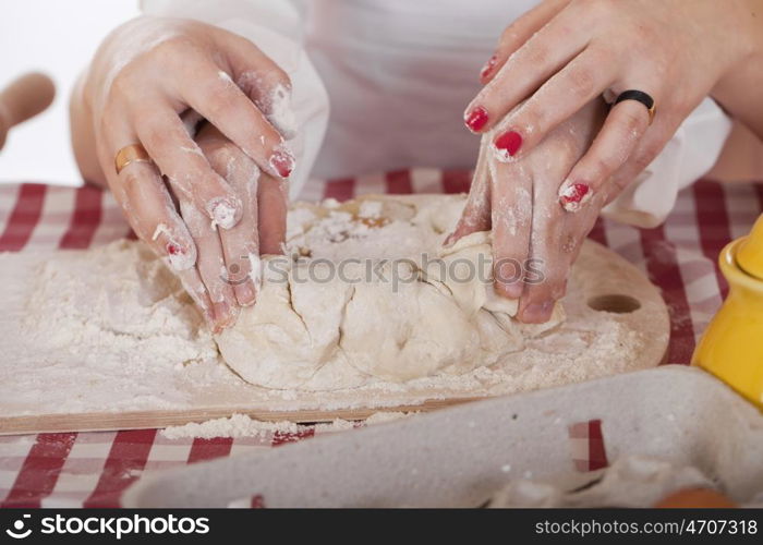 Caring Hands mother helping her daughter prepare dough