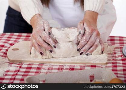 Caring Hands mother helping her daughter prepare dough