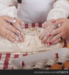 Caring Hands mother helping her daughter prepare dough