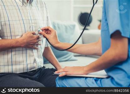 Caring young female doctor examining her contented senior patient with stethoscope in living room. Medical service for elderly, elderly sickness, declining health.. Caring young female doctor examining her contented senior patient.