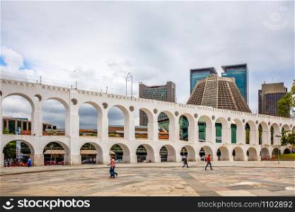 Carioca Aqueduct with Cathedral of Saint Sebastian and modern business buildings in the background, Rio De Janeiro, Brazil