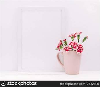 carnation flowers vase with empty frame table
