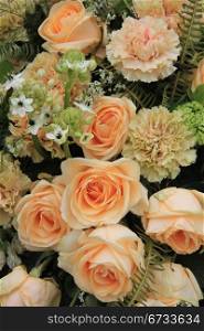Carnations and roses in a pale orange shade, floral composition