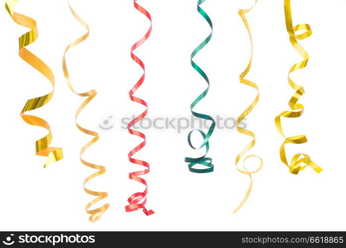 Carnaval festive curling paper decorations isolated on white background. Carnaval decorations on dark wooden background