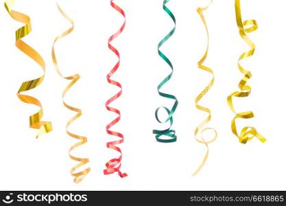 Carnaval festive curling paper decorations isolated on white background. Carnaval decorations on dark wooden background