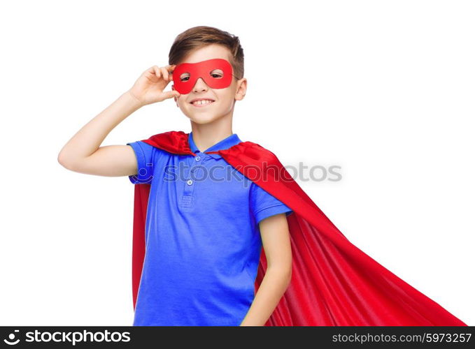 carnival, childhood, power, gesture and people concept - happy boy in red super hero cape and mask