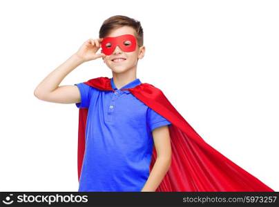 carnival, childhood, power, gesture and people concept - happy boy in red super hero cape and mask