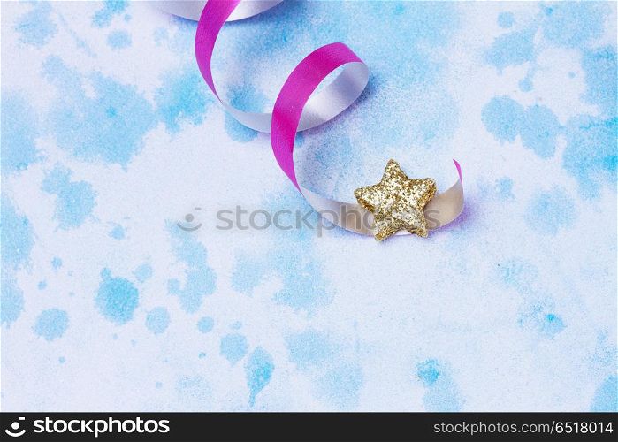 Carnival festive background. Bright colorful carnival or party scene of streamers and confetti on blue table.