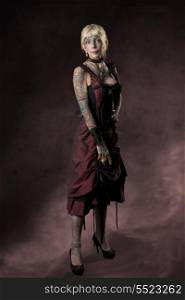 carnival full-length portrait of dark lady with red baroque dress, many tattoos and heels