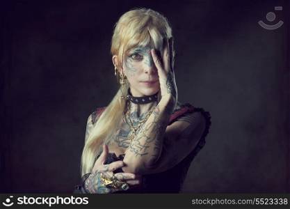 carnival portrait of pretty woman with bizarre gothic style and many tattoos