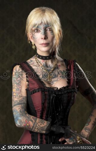 carnival portrait of tattoo woman with red gothic costume and gold ornaments