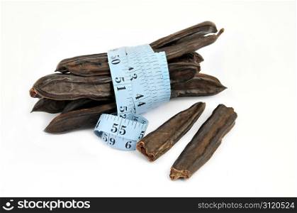 carob and measure on white background