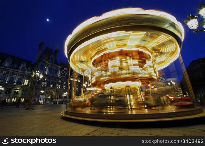 Carousel near Hotel de Ville, Paris, France. Rotating, full speed.