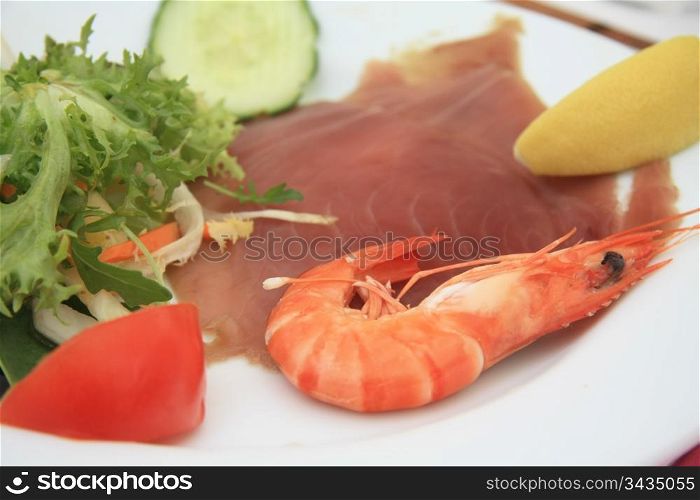 carpaccio of tunafish, served with a gamba and some salad