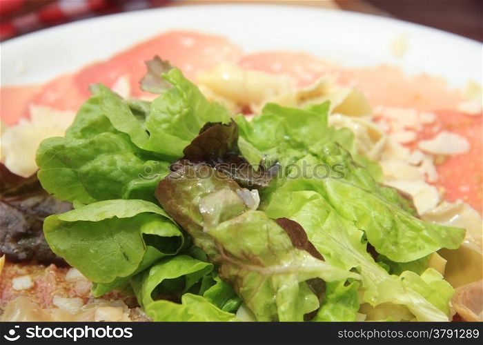 Carpaccio with lettuce and parmesan cheese