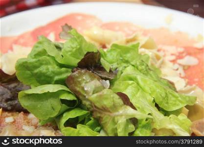 Carpaccio with lettuce and parmesan cheese