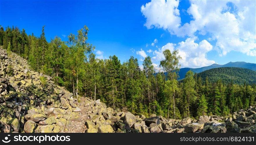 Carpathian Mountain summer landscape with sky and cumulus clouds, fir forest and slide-rocks (Gorgany, Ukraine). Four shots stitch panorama.