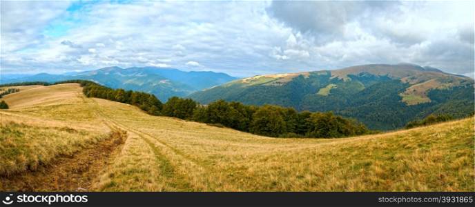 Carpathian Mountains (Ukraine) autumn landscape with country road. Panorama.