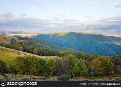 Carpathian Mountains (Ukraine) autumn landscape with green forest and overcast sky