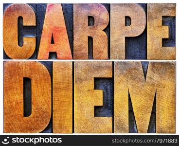 Carpe Diem - enjoy life before it is too late, existential cautionary Latin phrase by Horace - isolated text in vintage letterpress wood type printing blocks stained by color inks