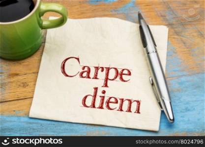 Carpe diem - handwriting on a napkin with a cup of coffee
