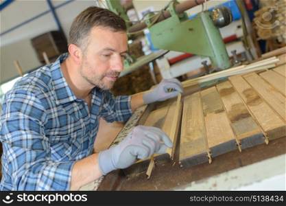 Carpenter aligning planks of wood