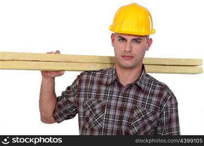 Carpenter carrying planks
