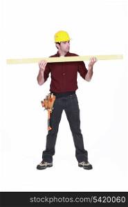 Carpenter holding a plank