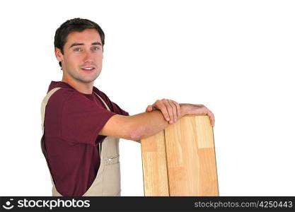 Carpenter holding planks of wood