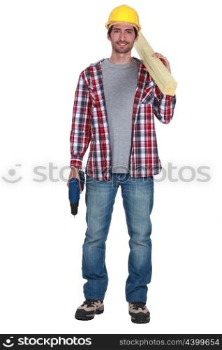 Carpenter holding planks of wood and power drill