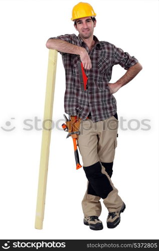 Carpenter leaning against a wooden plank