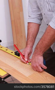 Carpenter measuring wood