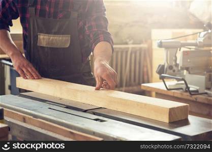 Carpenter planed wooden block with electric machine. Carpenter planed wooden block