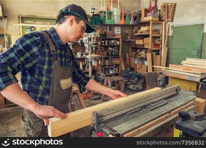 Carpenter planed wooden block with electric machine. Carpenter planed wooden block
